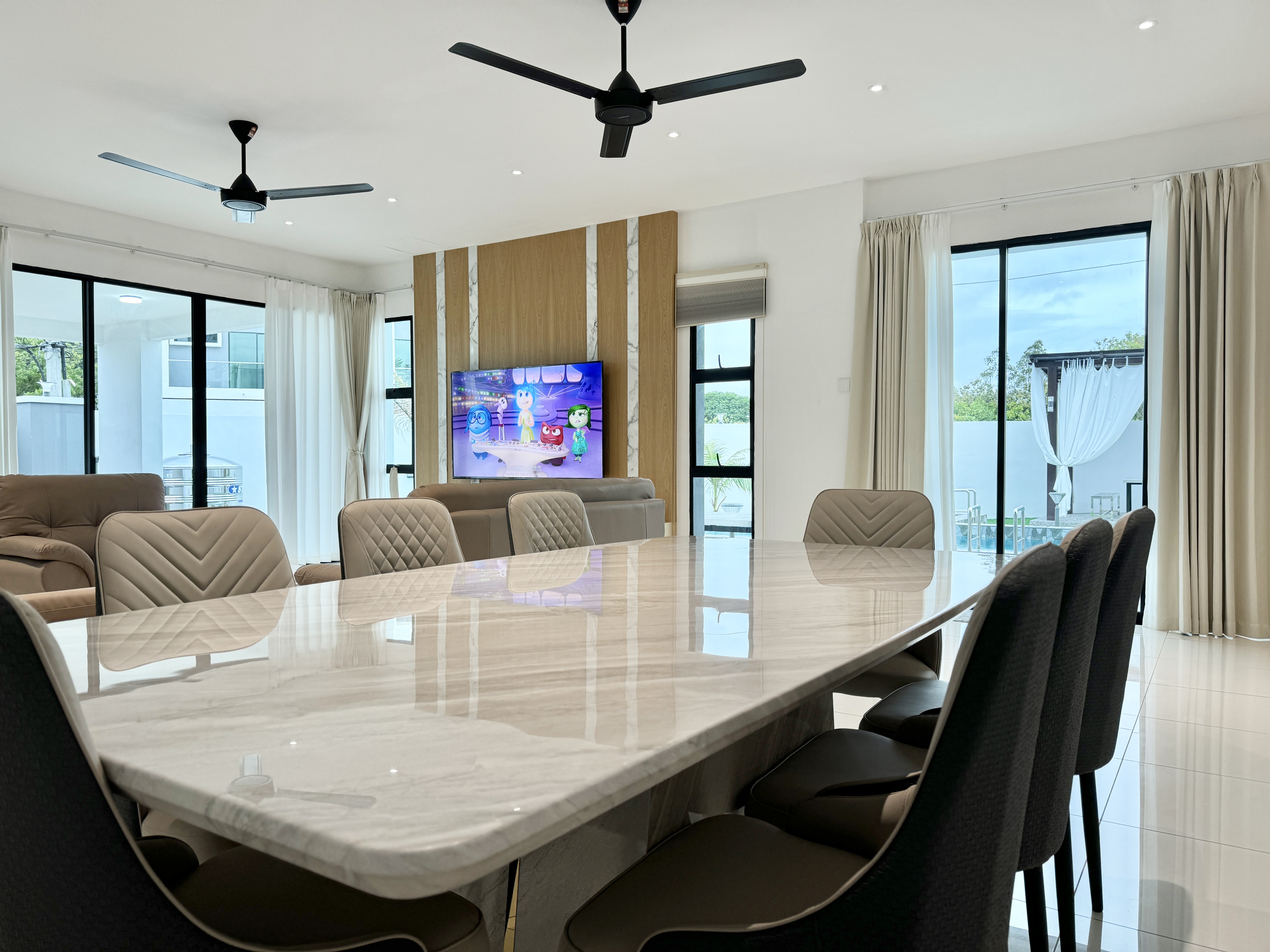 Family bungalow in Langkawi with marble dining table and pool view — managed short-term rental